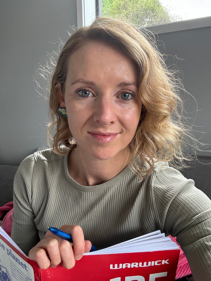 Amanda McKenzie holding a notebook and pen